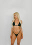 Woman wearing a black bikini against a plain background