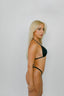 Woman wearing a black bikini against a plain background